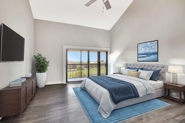 a spacious bedroom with a large bed and a flat screen tv