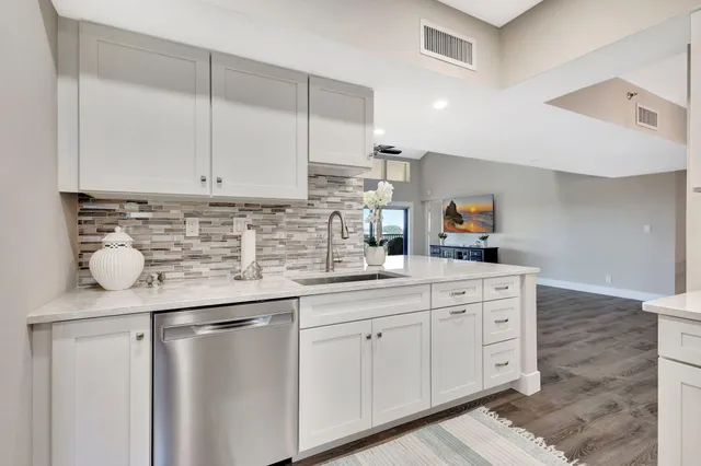 a kitchen with cabinets appliances and a sink