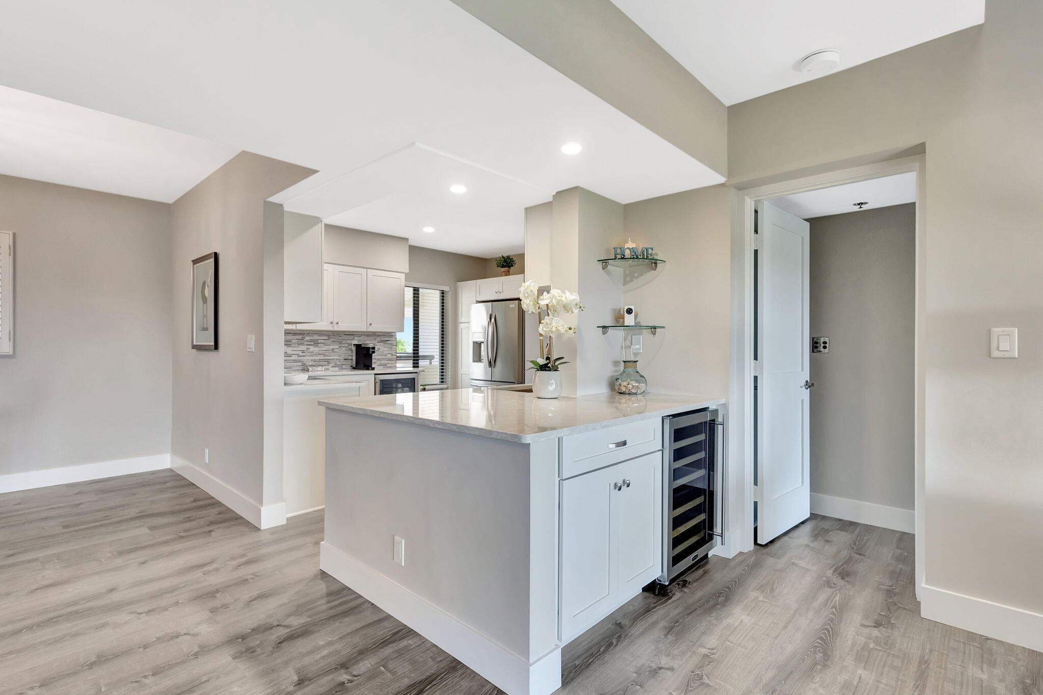 16940 Bay Street, Unit N505 Jupiter, FL 33477 - Photo 9 of 39 a kitchen with white cabinets and stainless steel appliances