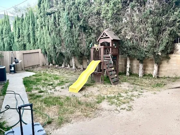 a swing hanging chair with a slide in the patio