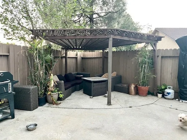 a view of a patio with table and chairs potted plants