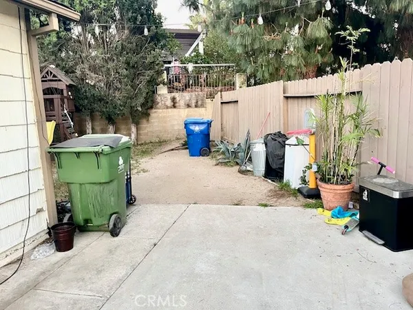 a view of a chair and table in backyard