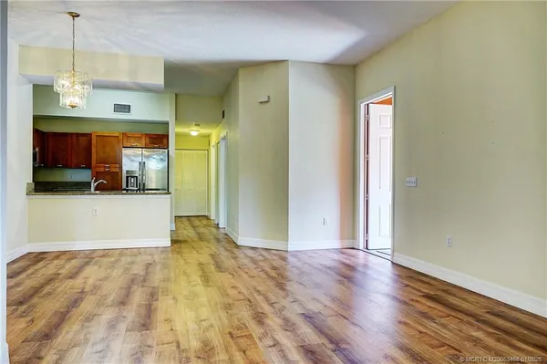 a kitchen with stainless steel appliances granite countertop a refrigerator a stove top oven a sink and dishwasher