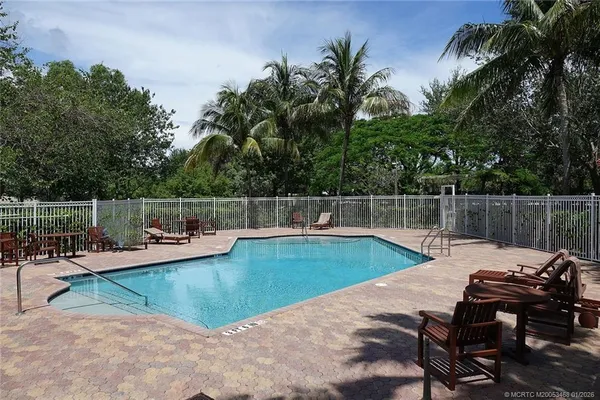 a view of a swimming pool with chairs