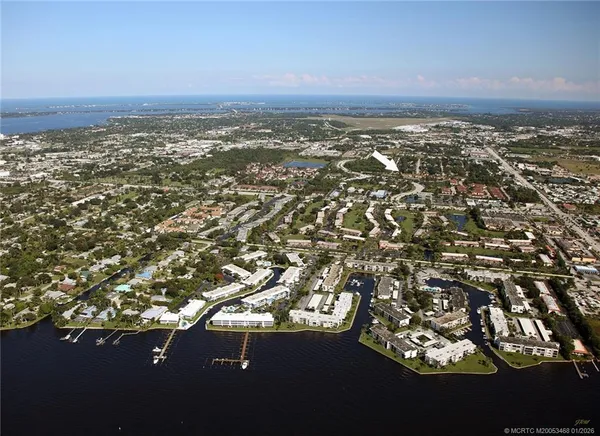 an aerial view of residential building and trees around