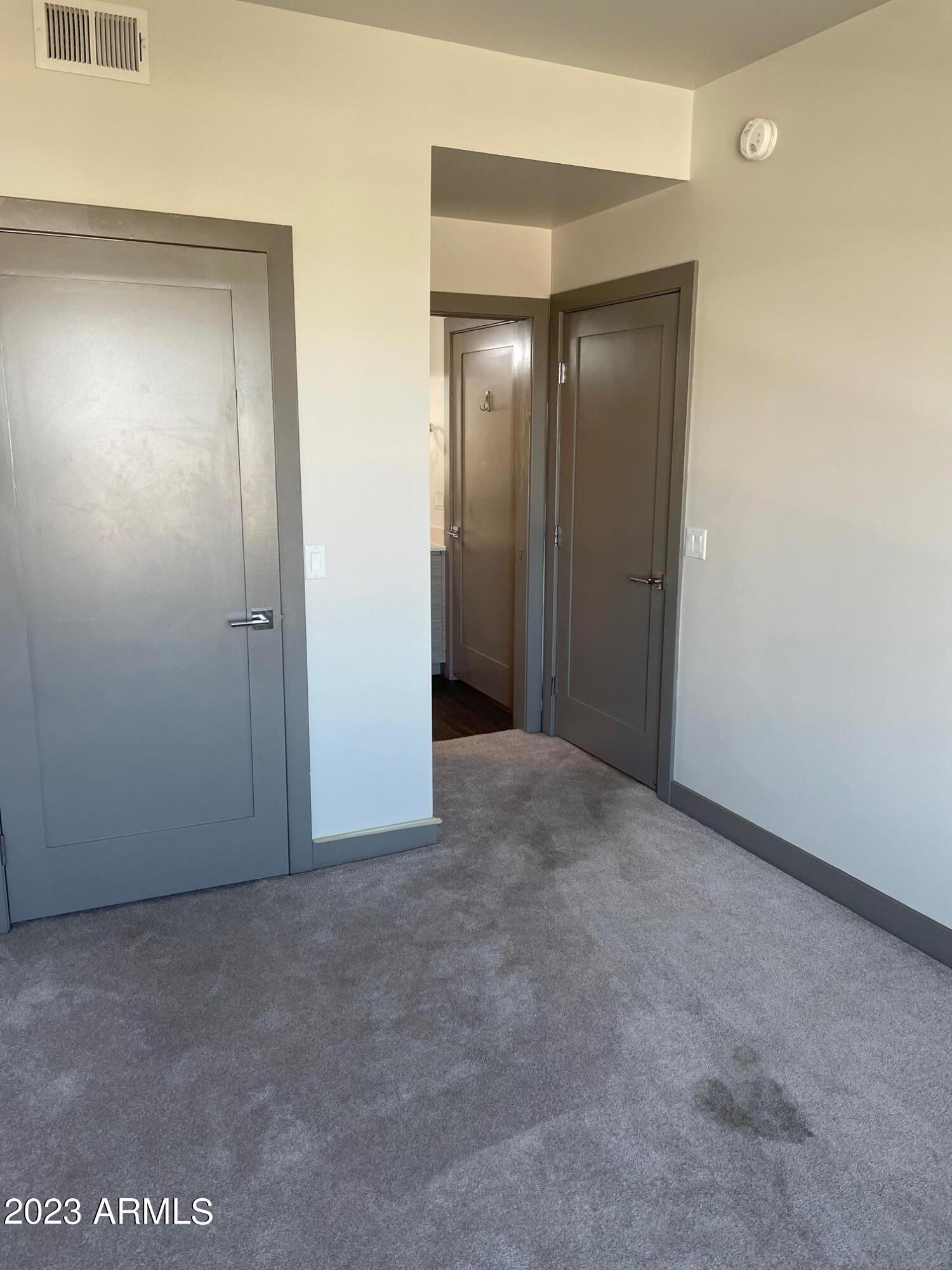 425 West Osborn Road, Unit 210 Phoenix, AZ 85013 - Photo 11 of 31 an empty room with closet and mirror