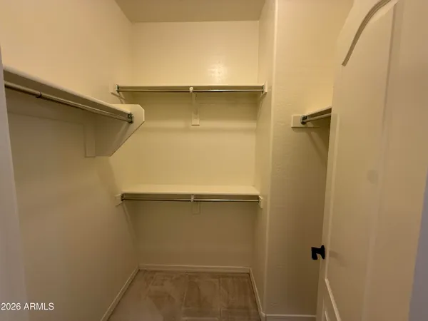 a white toilet sitting next to a wooden cabinet