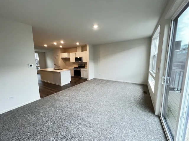 a view of a kitchen with a sink and a refrigerator
