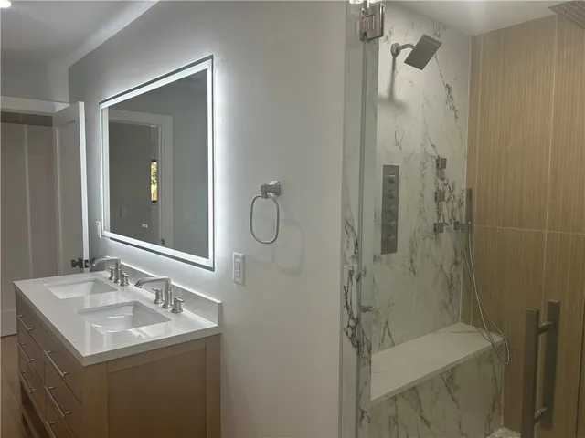 a bathroom with a granite countertop bathtub toilet and sink