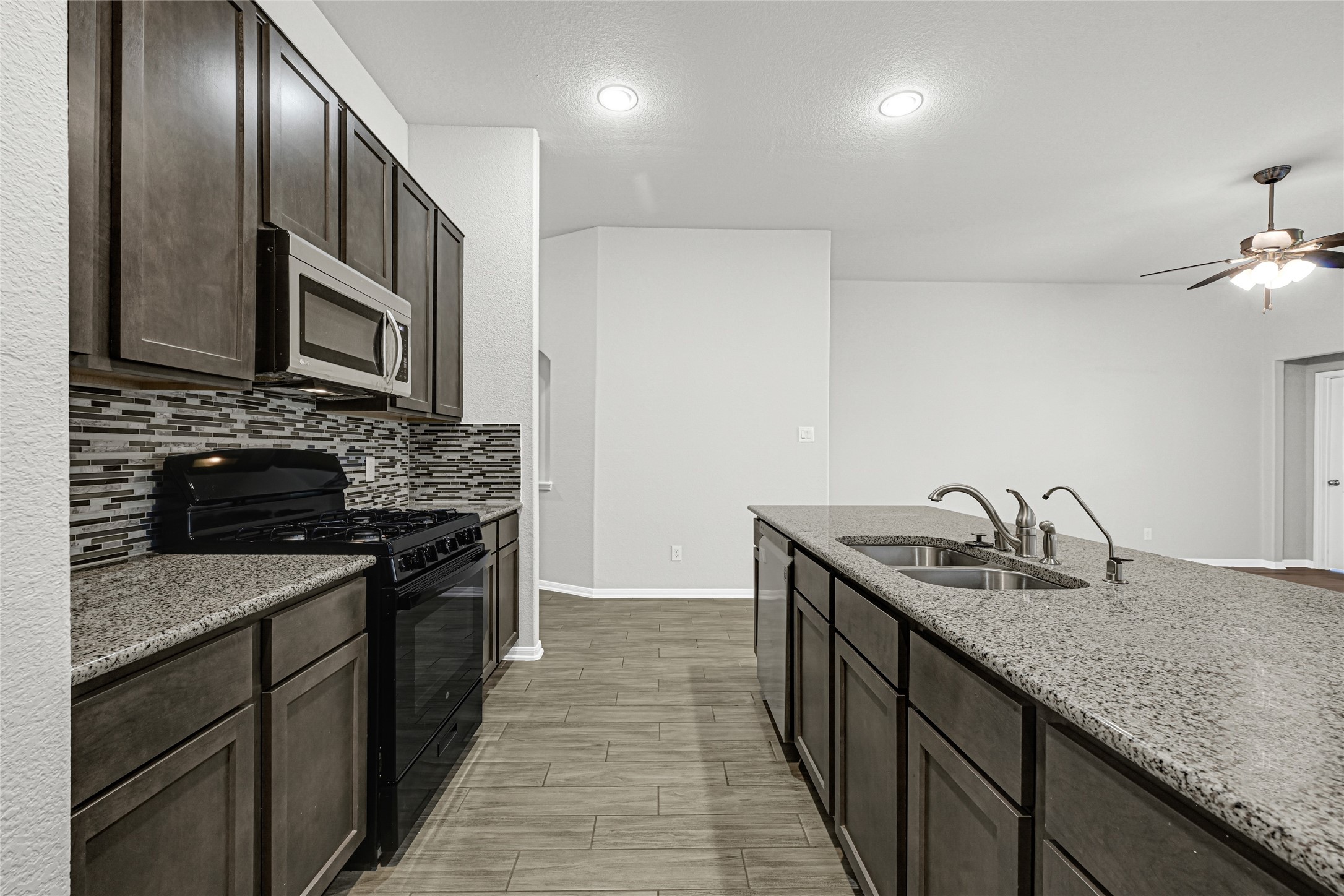 2249 Yellow Fern Path Spring, TX 77386 - Photo 12 of 49 a kitchen with granite countertop stainless steel appliances and wooden cabinets