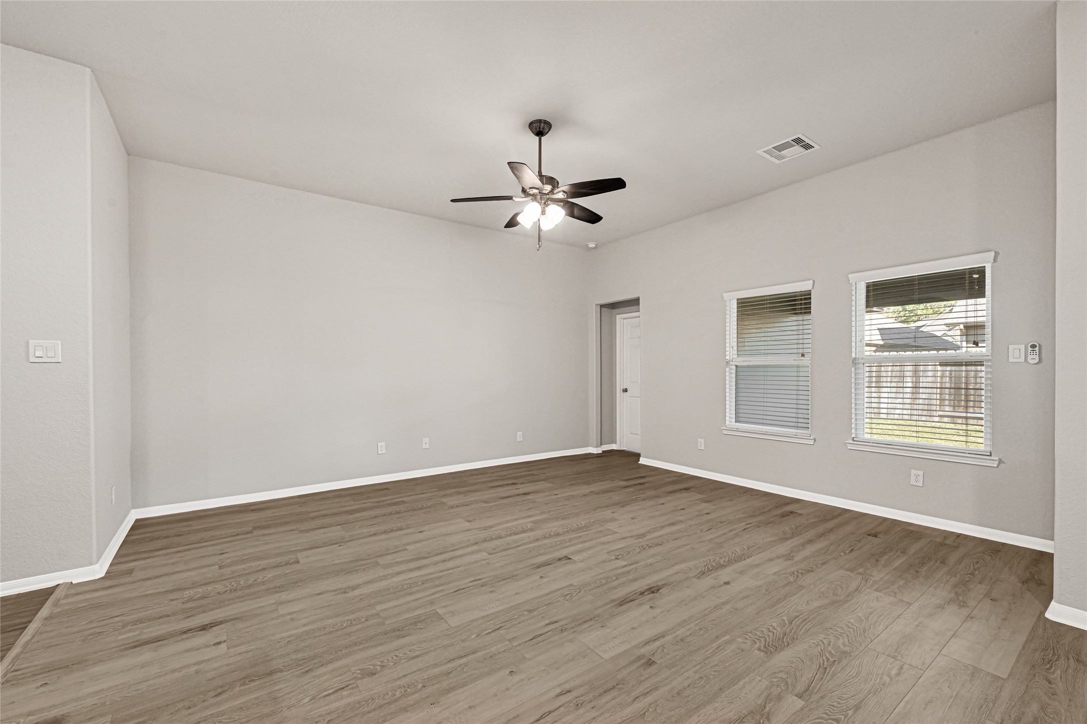 2249 Yellow Fern Path Spring, TX 77386 - Photo 20 of 49 a view of an empty room with a window and wooden floor