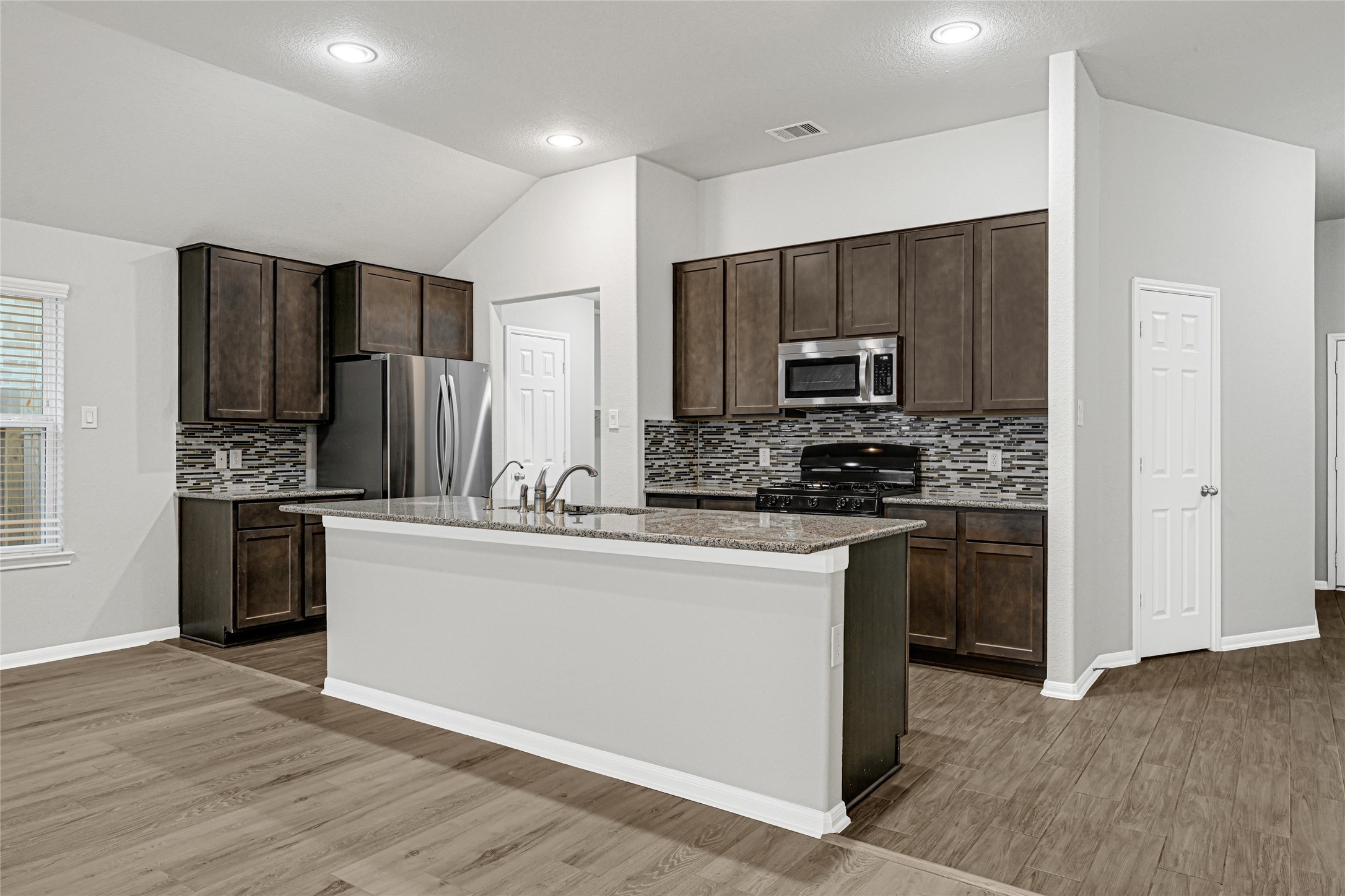 2249 Yellow Fern Path Spring, TX 77386 - Photo 3 of 49 a kitchen with stainless steel appliances a refrigerator and a stove top oven
