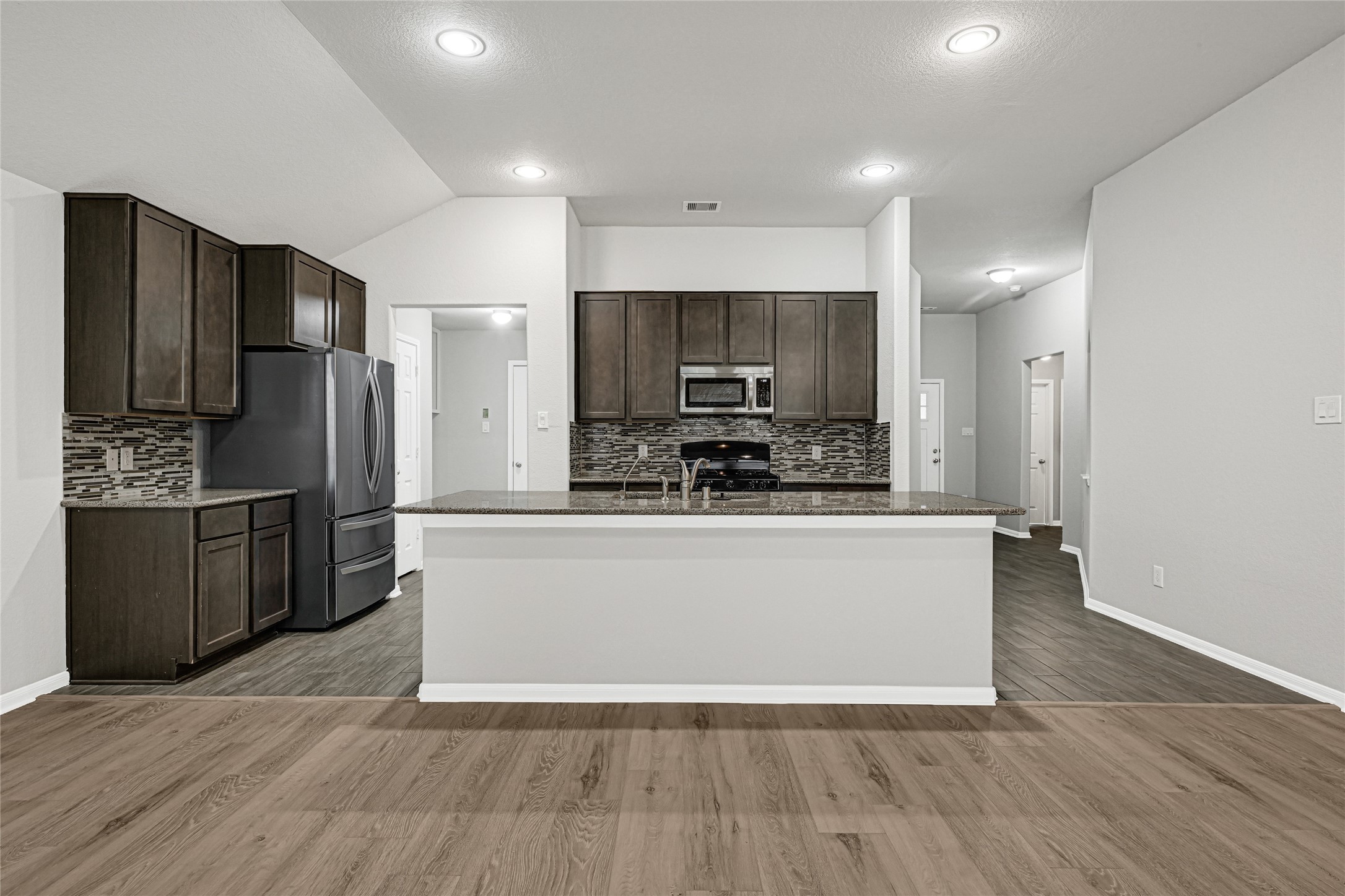 2249 Yellow Fern Path Spring, TX 77386 - Photo 4 of 49 a large kitchen with stainless steel appliances a refrigerator and a stove top oven