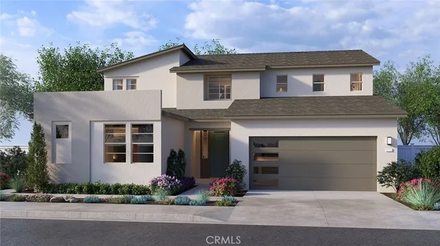 a front view of a house with a garden and yard