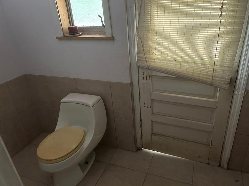 2060 East Mary Lue Street Inverness, FL 34453 - Photo 20 of 25 a white toilet sitting next to a shower