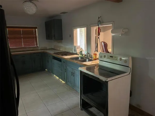 a kitchen with a sink stove and cabinets