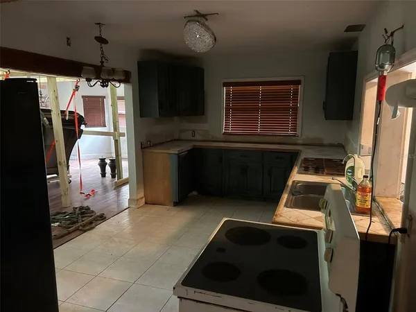 a kitchen with a refrigerator and a stove