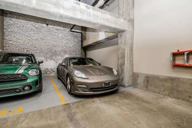 a view of parking garage with cars