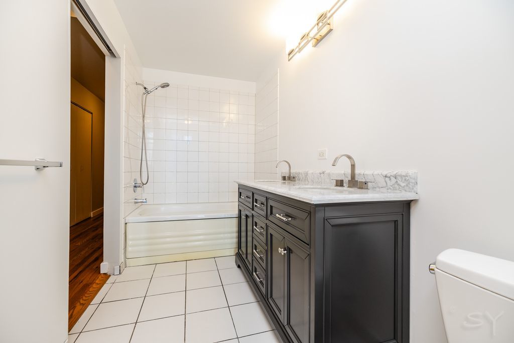 1720 South Michigan Avenue, Unit 1606 Chicago, IL 60616 - Photo 6 of 16 a bathroom with a sink a toilet and shower