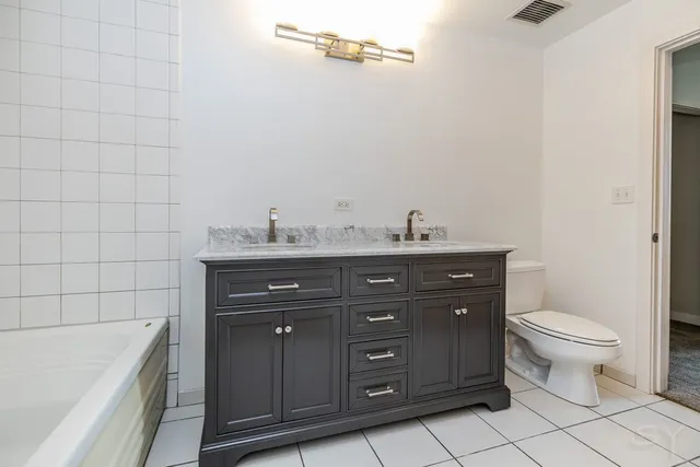 a bathroom with a sink a toilet and bathtub