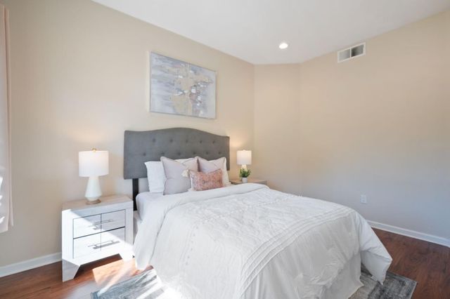 a bedroom with a bed and a night stand