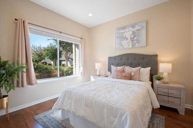 a bedroom with a bed and a large window