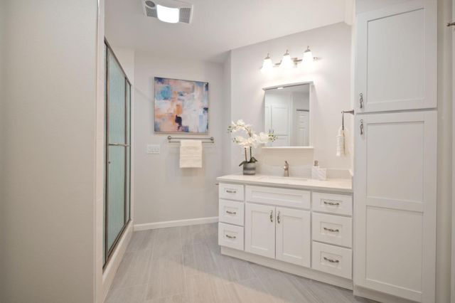 a spacious bathroom with a double vanity sink and a mirror