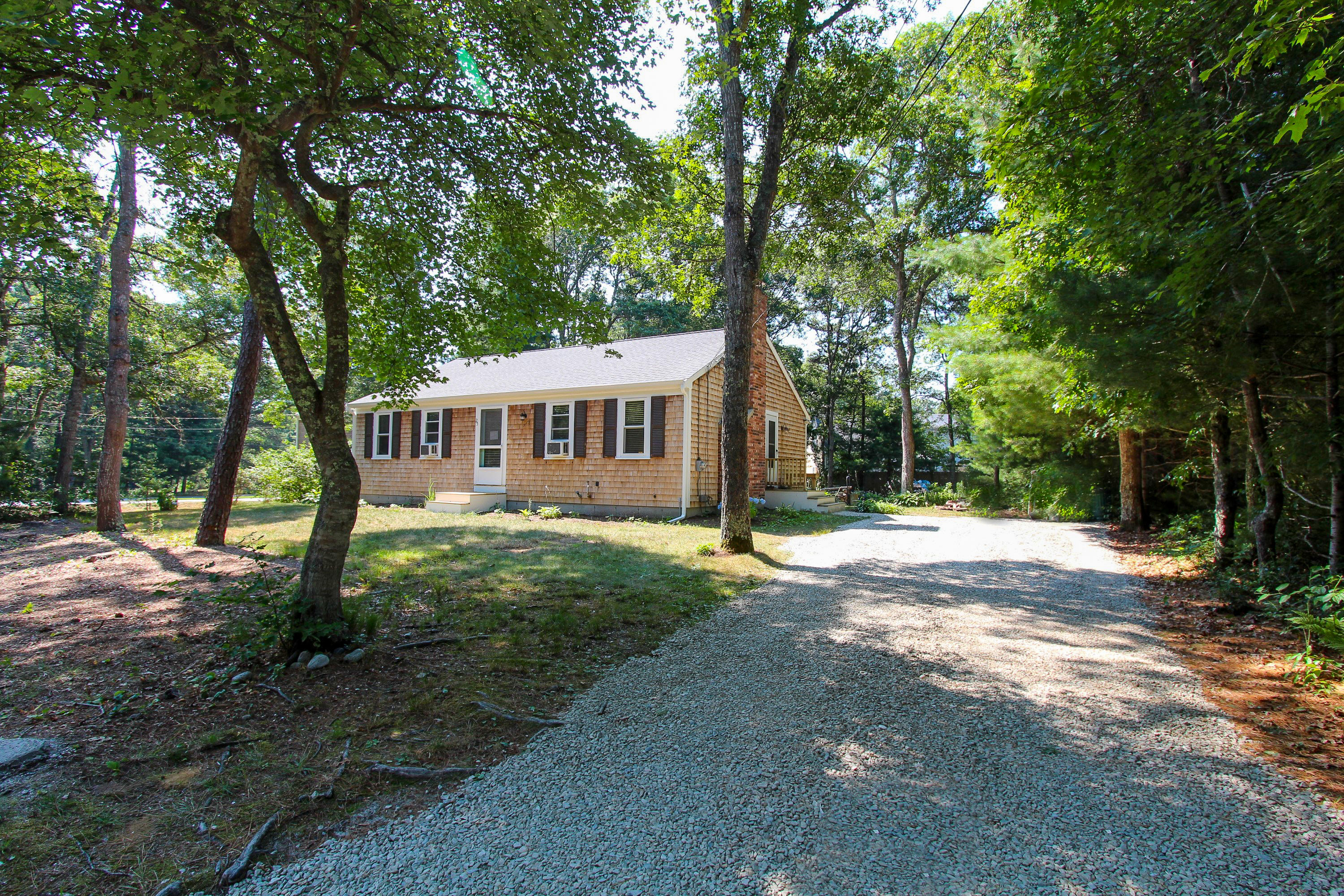 25 Bridgets Path Centerville, MA 02632 - Photo 1 of 23 a view of a house with backyard and trees