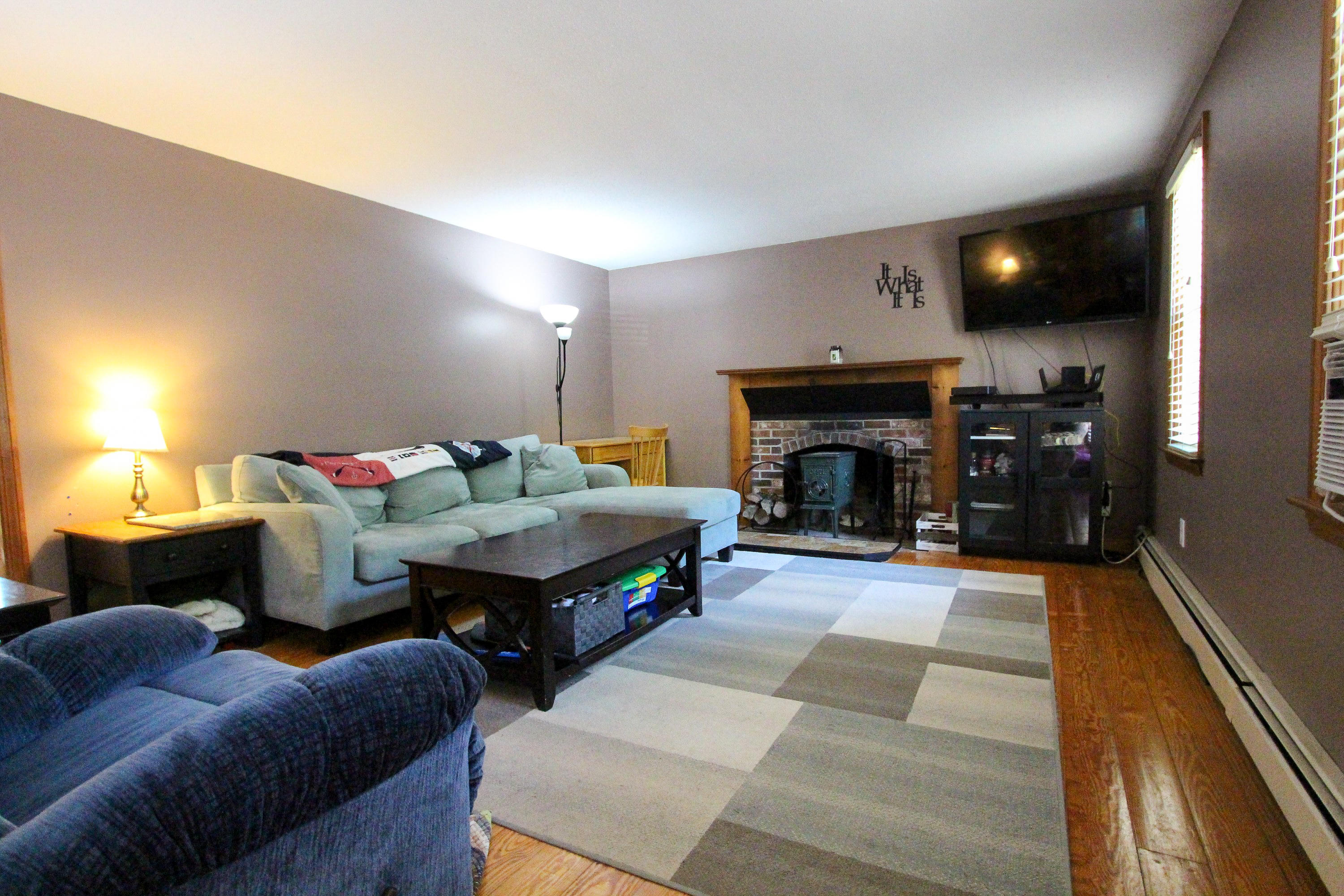 25 Bridgets Path Centerville, MA 02632 - Photo 13 of 23 a living room with furniture a fireplace and a flat screen tv