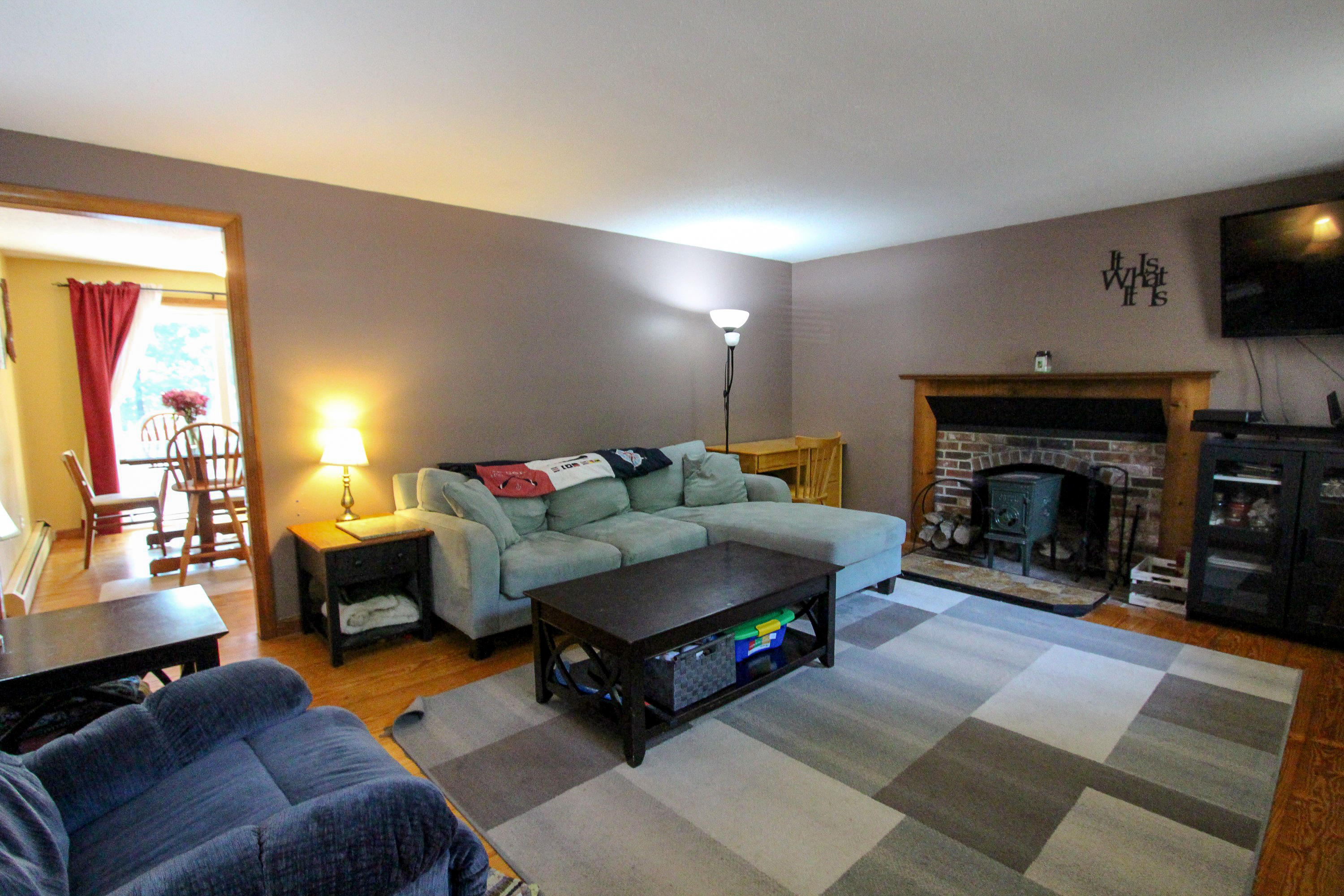 25 Bridgets Path Centerville, MA 02632 - Photo 15 of 23 a living room with furniture a flat screen tv and a fireplace