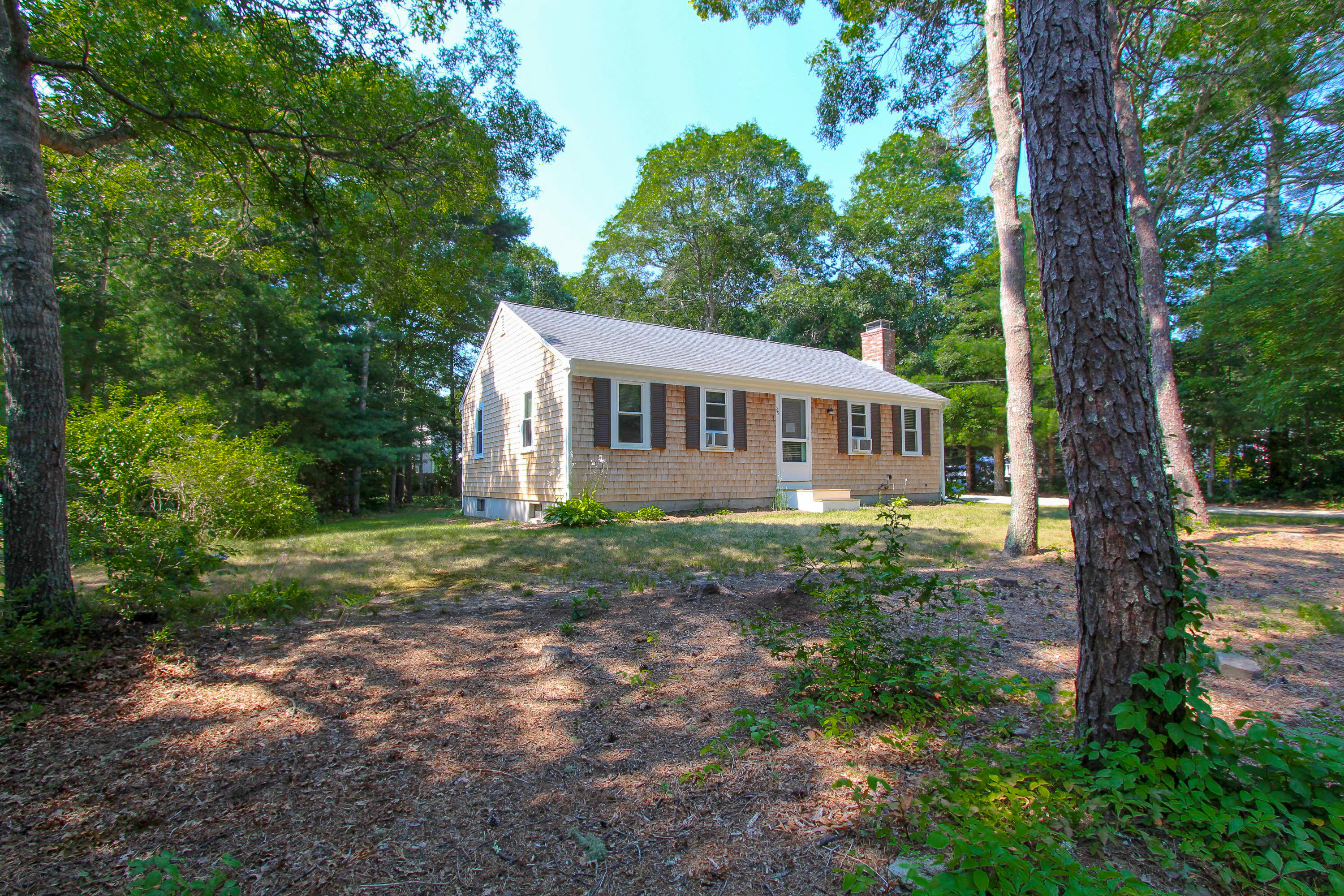25 Bridgets Path Centerville, MA 02632 - Photo 21 of 23 a view of house with yard and trees in the background