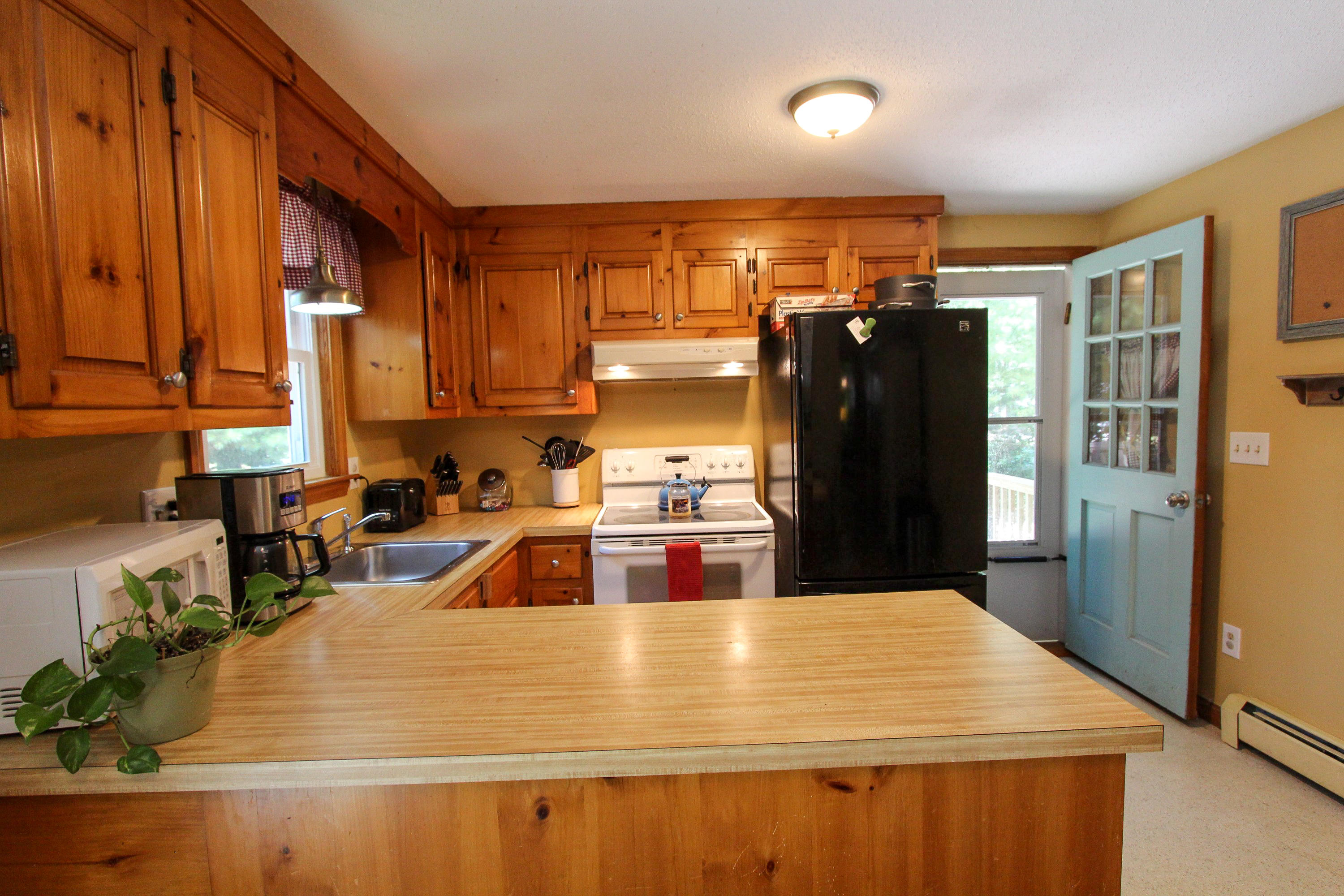 25 Bridgets Path Centerville, MA 02632 - Photo 5 of 23 a kitchen with stainless steel appliances wooden floor dining table and chairs