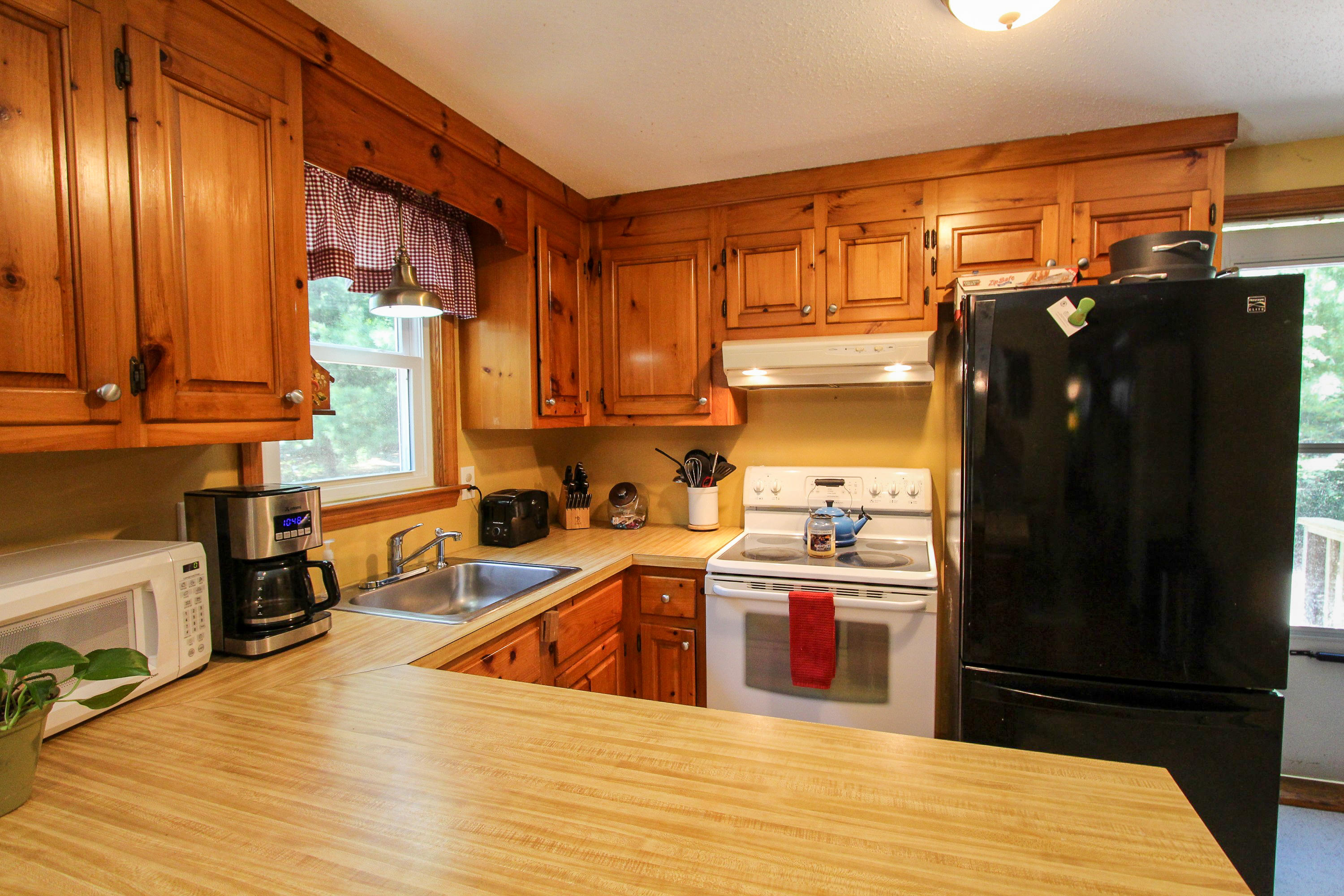25 Bridgets Path Centerville, MA 02632 - Photo 6 of 23 a kitchen with stainless steel appliances granite countertop a refrigerator a sink dishwasher and wooden cabinets