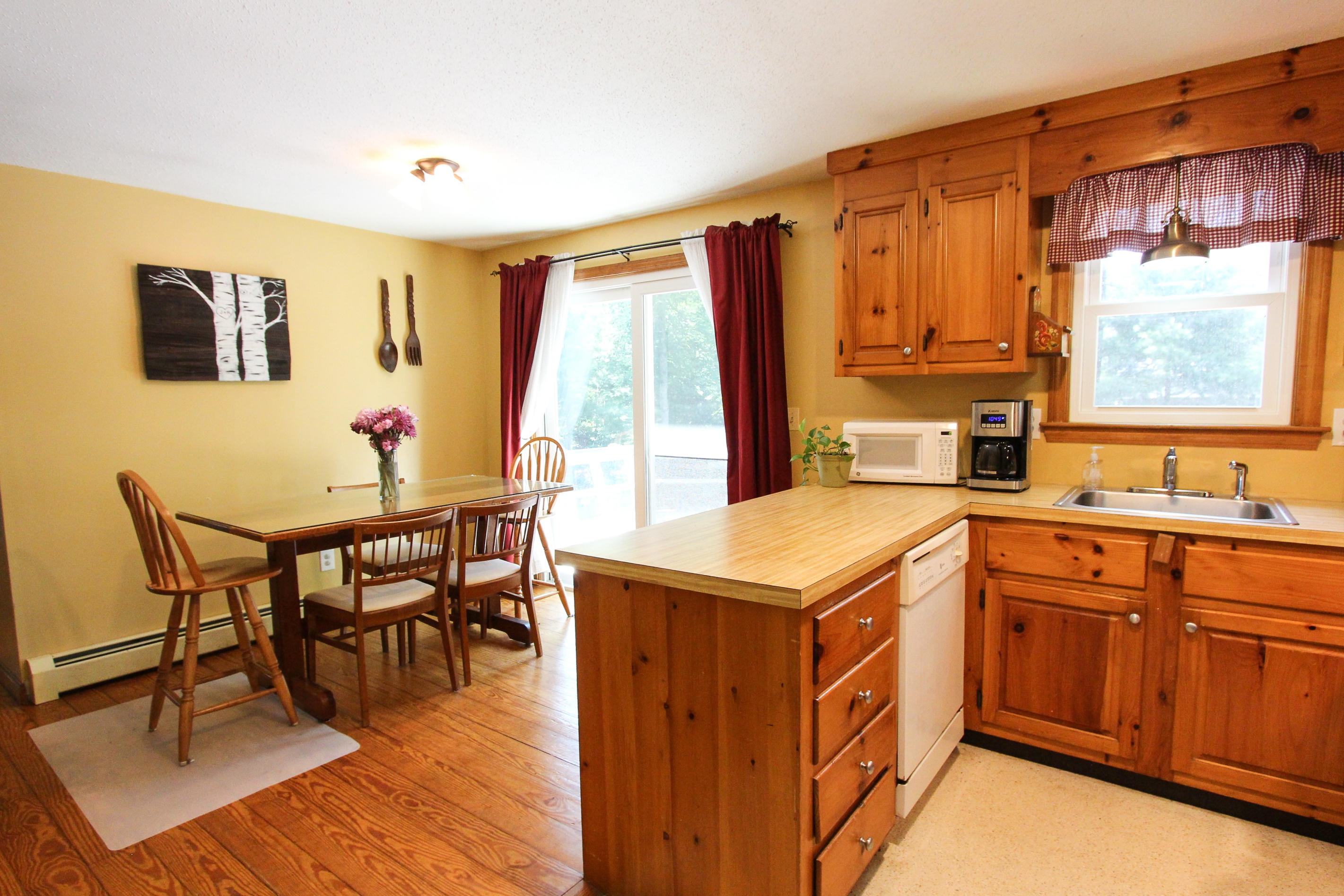 25 Bridgets Path Centerville, MA 02632 - Photo 8 of 23 a view of a kitchen area with furniture and wooden floor