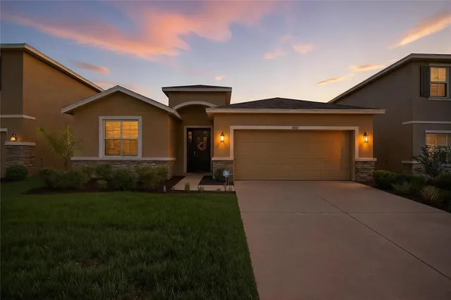 a front view of a house with a yard and garage