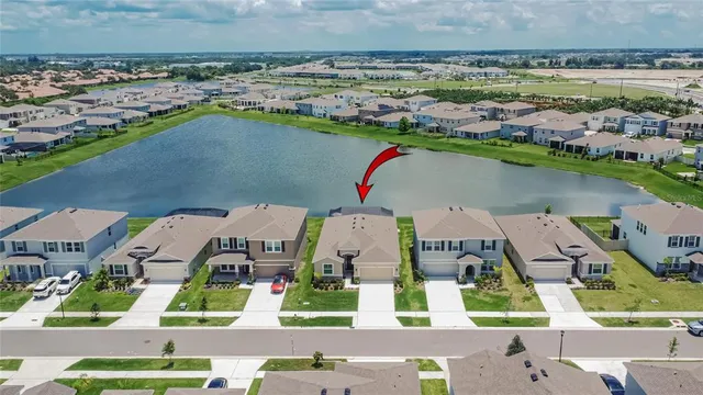 an aerial view of residential houses with outdoor space and swimming pool