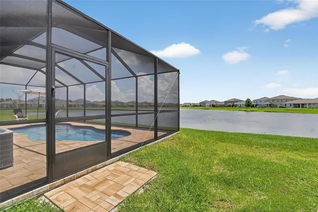 a bedroom with a bed and a lamp on table