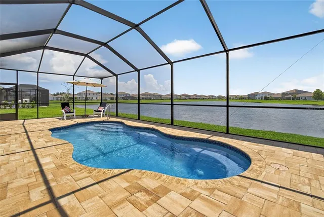 a large kitchen with granite countertop lots of counter space and stainless steel appliances