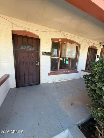 a view of a house with porch and furniture
