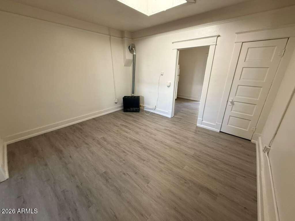 647 East 8th Street Douglas, AZ 85607 - Photo 4 of 11 an empty room with wooden floor and closet