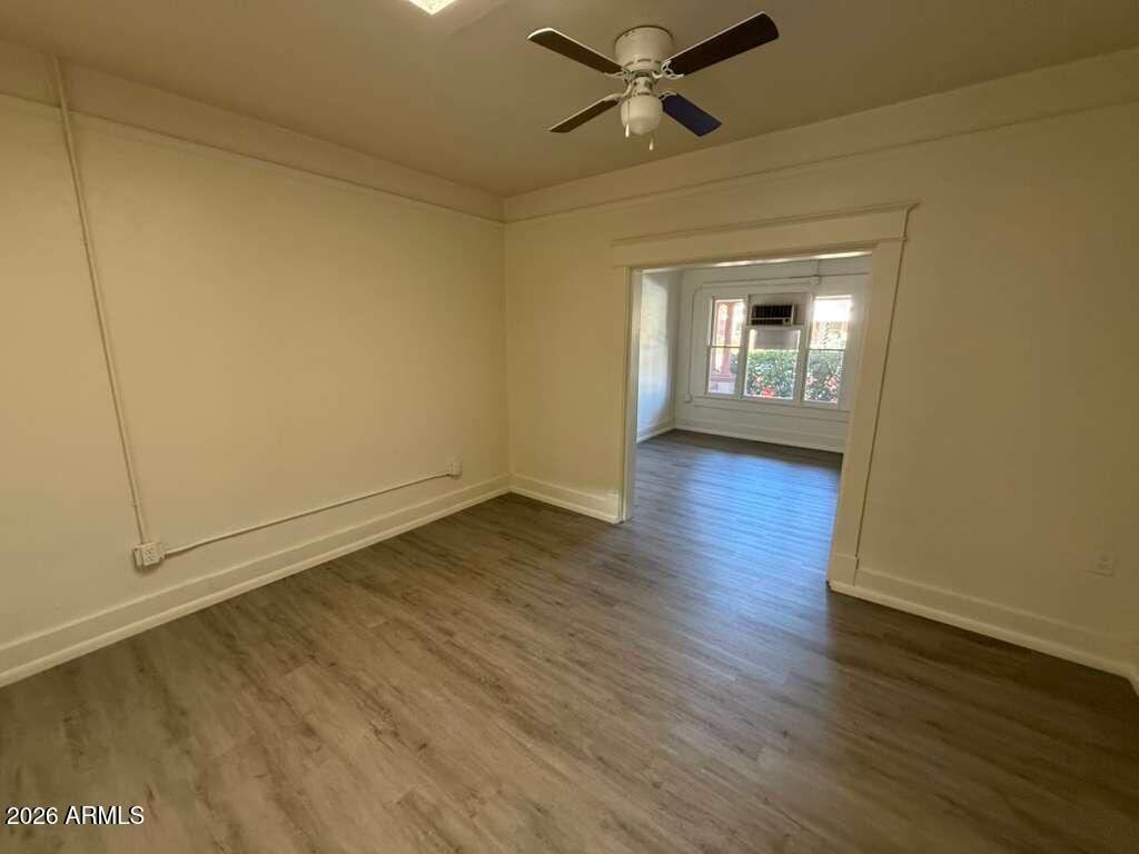 647 East 8th Street Douglas, AZ 85607 - Photo 5 of 11 a view of empty room with wooden floor and fan