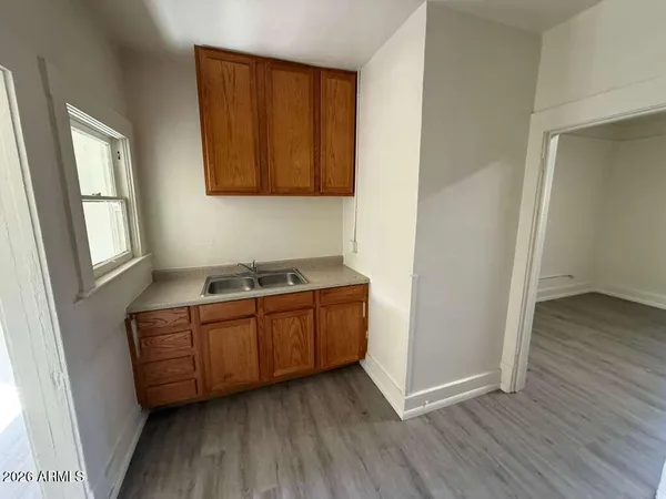 a room with granite countertop wooden floors and sink