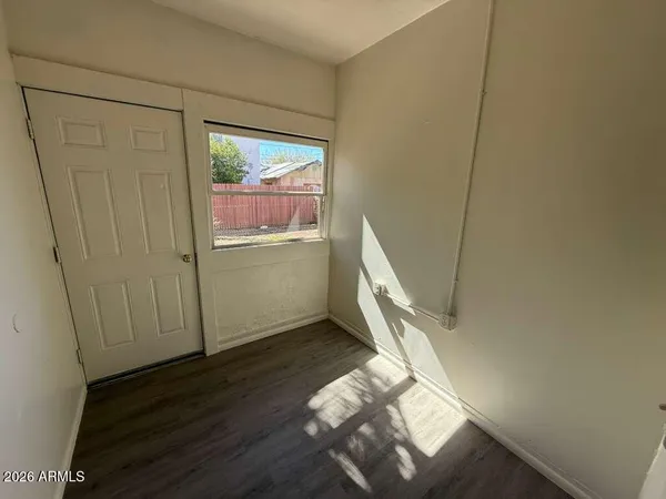 a view of an empty room and wooden floor
