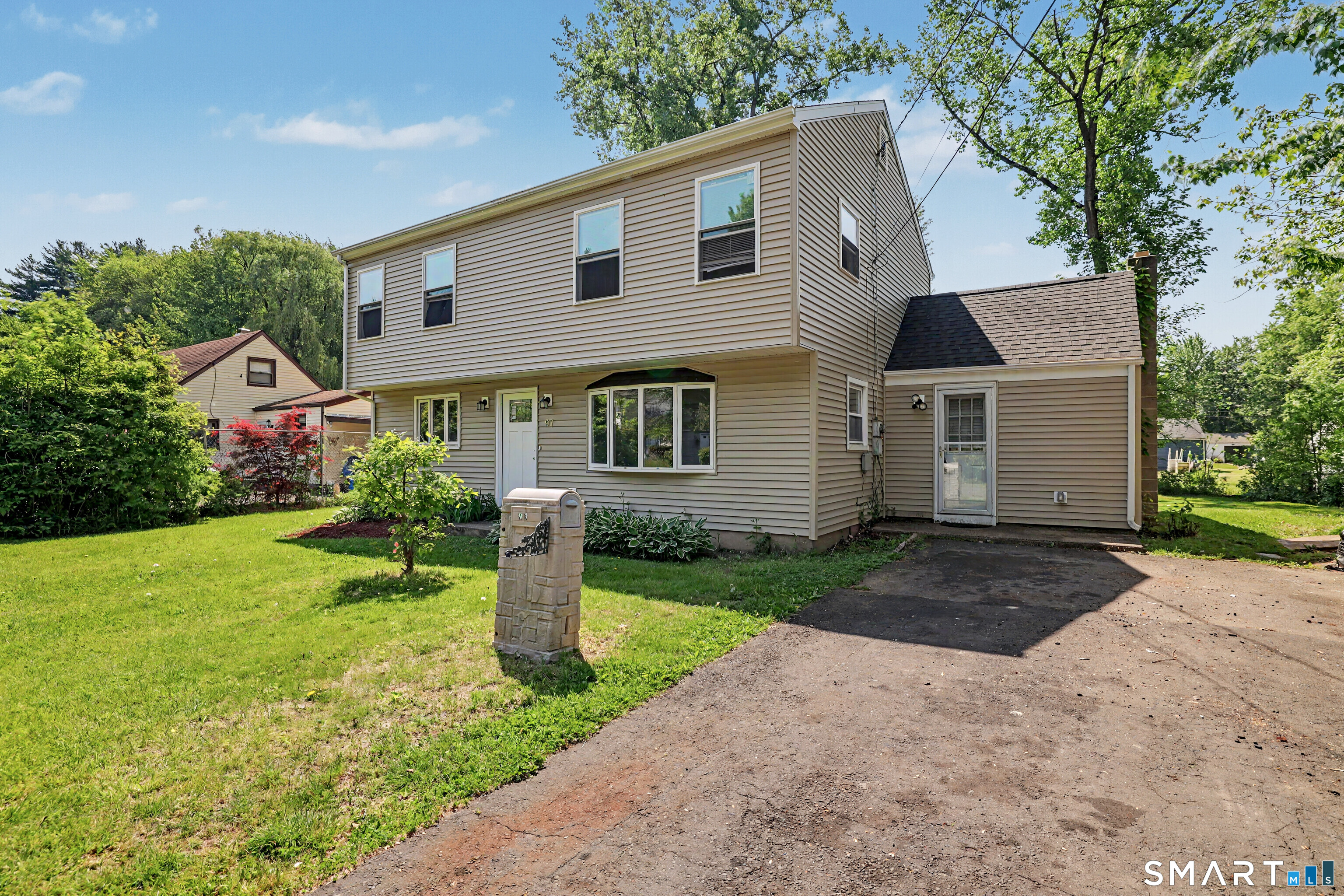 97 Boothbay Street Bloomfield, CT 06002 - Photo 1 of 33 a front view of a house with a yard and garage