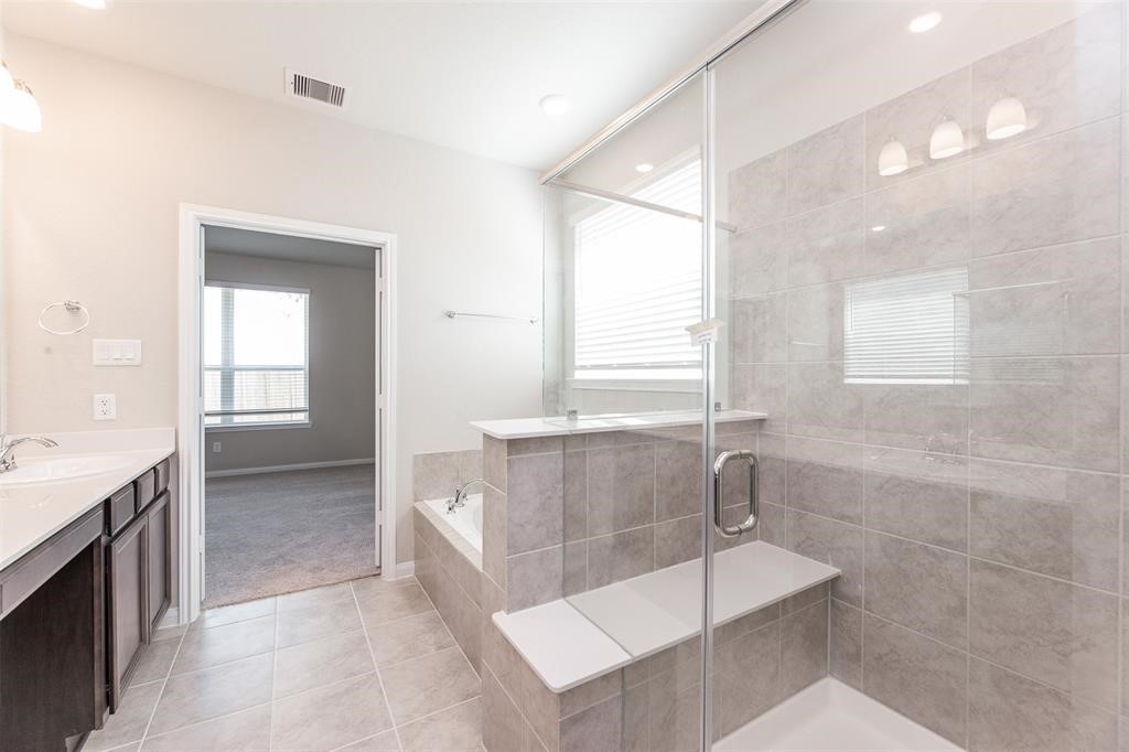 1230 Glendora Drive Rosharon, TX 77583 - Photo 16 of 28 a bathroom with a tub a sink and mirror