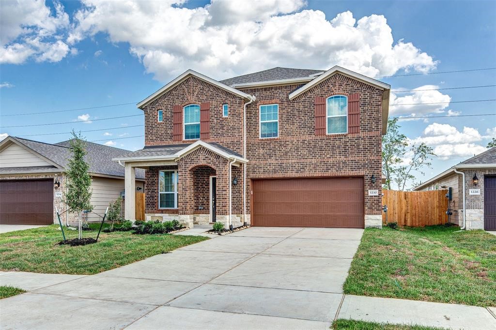 1230 Glendora Drive Rosharon, TX 77583 - Photo 2 of 28 a front view of a house with a garden