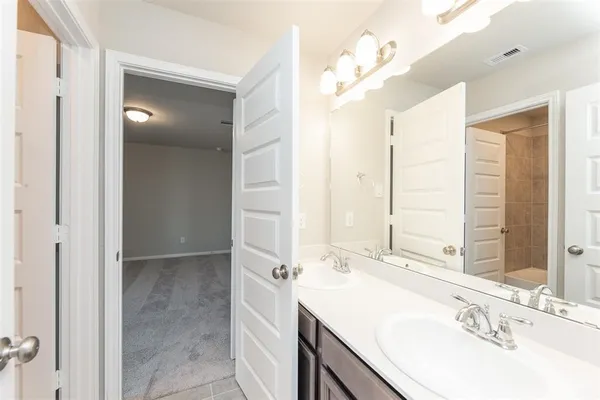 a bathroom with a sink a vanity and a mirror