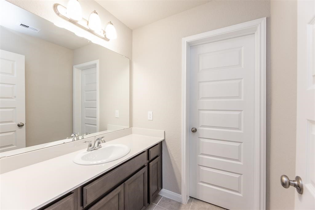 1230 Glendora Drive Rosharon, TX 77583 - Photo 26 of 28 a bathroom with a sink a vanity and a mirror
