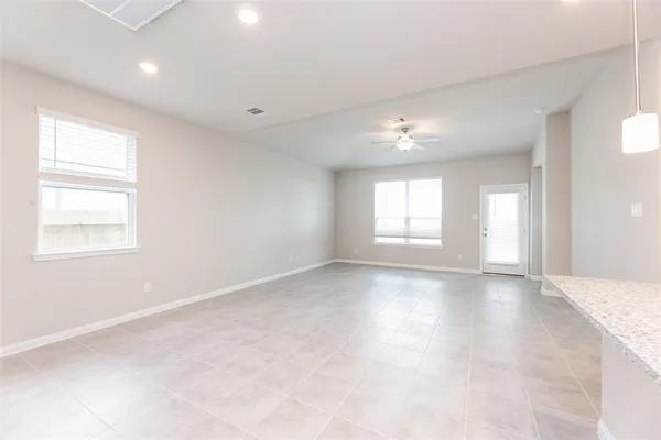 an empty room with windows and closet