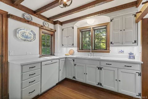 a kitchen with a sink window and cabinets